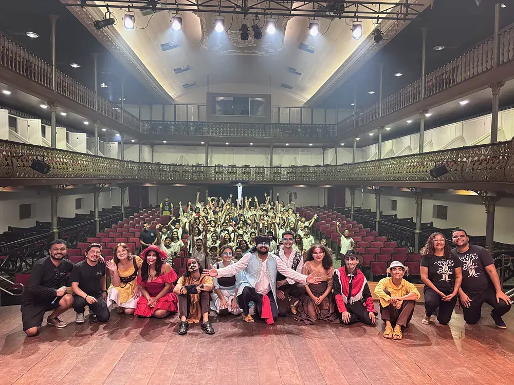 Alunos no teatro com o elenco da peça